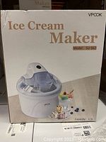Box showing VPcook Ice Cream Maker model SU-562 with 1.5L capacity and food imagery on front.
