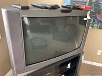 Photo of large RCA analog CRT TV with curved screen and gray casing