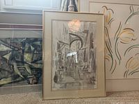 Framed artworks grouped showing abstract, cityscape, and floral line art