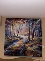 Full view of oversized forest landscape painting featuring trees and a stream in vivid, impressionistic colors.