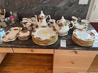 Overview of all dinnerware, tea and coffee pieces on countertop