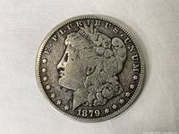 Obverse view of the 1879 S Morgan Silver Dollar showing Lady Liberty and date 1879.
