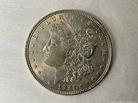 Obverse side of the 1921 Morgan silver dollar coin showing Lady Liberty and coin date.