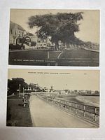 Two black and white antique postcards laid flat on a surface, showing both in one photo. Captures overall look and condition.