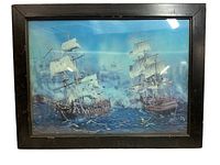 Framed 3-D art depicting two sailing ships on the sea with white sails and blue water background, viewed from front.