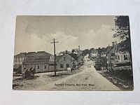 Front side of the antique postcard showing a railroad crossing and street scene in Bay View, Mass.