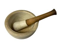 Top view showing mortar interior and wooden pestle within bowl.