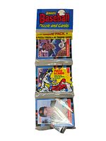 Top view of the three sealed packages: Donruss Baseball Puzzle and Cards package with 9 puzzle pieces and 45 trading cards.
