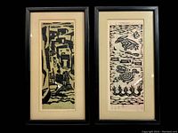 Front view of both framed block prints side by side showing abstract designs , black frames and cream mats
