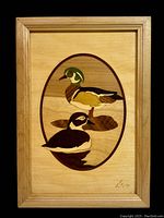 Full front image showing wooden inlay ducks artwork signed bottom right.