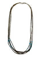 Full view of the sterling Native American liquid silver necklace with turquoise beads, 16 inches long, arranged in a circle to show entire length and bead arrangement.