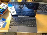 Open Asus laptop showing keyboard, screen, and Intel Inside and HDMI stickers.