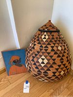 Basket and art print side by side against wall