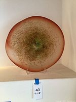 Front view of round glass plate on stand