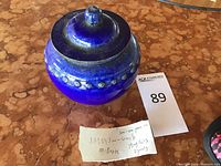 Top and side view of the blue glazed vase with lid and note indicating Ming Qing dynasty origin and approximate age of 300-400 years.