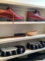 Brown leather lace-up shoes on shelf.