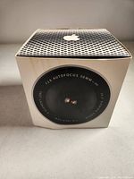 Front view of the Apple iSight webcam original box highlighting the 50mm f/2.8 autofocus lens graphic.