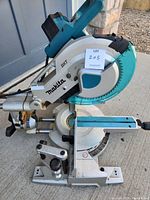 Angled side view showing blade, motor housing, laser guide and dual slide arms