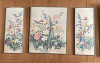 Three framed floral art pieces arranged on floor showing the set: one larger square panel and two smaller vertical panels.