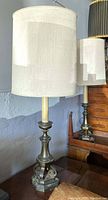 Pair of tall vintage lamps with heavy metal Eiffel Tower style bases and original light fabric shades.