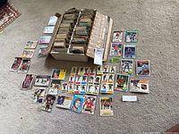 Card box filled with hundreds of loose hockey cards and a sample spread of loose cards around it