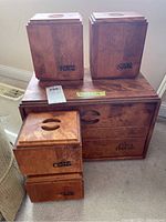 Photo showing the full set of wooden kitchen storage items, including the breadbox and the four canisters labeled flour, sugar, coffee, and tea.