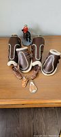Mounted Royal Canadian Mounted Police figurine on black horse displayed with horse boots and keychains