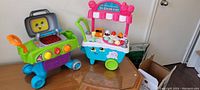Photo of the Leapfrog BBQ grill and Scoop & Learn Ice Cream Cart together on table.