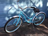 Full side view of the light blue Pacific women's cruiser bicycle showing frame, wheels, fenders, and saddle