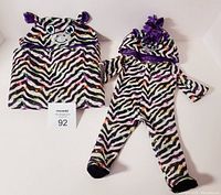 Photo of zebra print hooded sleeper pajamas and matching sleeping bag blanket with animal face and ears hoods for 18 inch dolls.