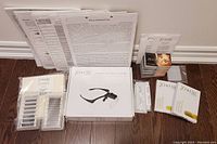 Overview photo showing the kit components including magnifying specs, instruction sheets, lash trays, and packets