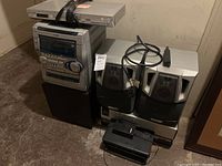 AIWA stereo system with Panasonic DVD player stacked on top and HP printer in foreground with Husky extension cord coiled on stereo.