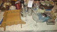 Photo showing four Mikasa Cheers etched martini glasses, metal cocktail shaker, small carved wooden tray, and other kitchen items.