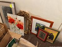 Photo showing all six items grouped against a wall including the ornate gold gilt framed mirror and five other framed prints/posters of various sizes and styles.