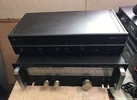 Front view of Arcam Alpha CX stereo amplifier stacked on top of Audio Research ST-2000 tuner, showing overall units and controls