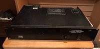Full front view of BGW Systems Commercial Power Amplifier Model 2125 sitting on wooden surface.