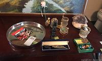 Display of all items on table including large amethyst, mortar and pestle, totem, small figurine, smoking caddy, and cutting tool.