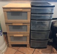Front view of two storage towers: laminated wood with translucent drawers on the left; black plastic with translucent drawers on the right.