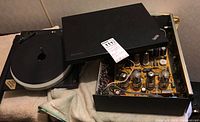 Photo showing Lenovo ThinkPad SL-500 laptop on top of Champion PC-35 amplifier with visible vacuum tubes.