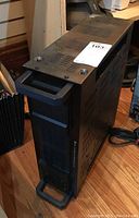 Front side view of TOA dual power amplifier showing ventilation grille and handle, black metal body with some wear marks.