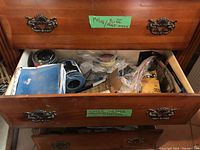 Open chest drawer showing automotive sandpaper, polishing compounds, and other related materials including 3M abrasive papers.