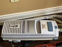 Top-down view of Electrolux Ambassador vacuum cleaner main body showing brand label, ventilation slots, and control panel area.