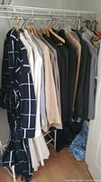 Photo showing a row of men's jackets hanging on a rack in various colors and styles, mostly size Large.