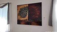 Full view of rectangular unframed wall art mounted on wall with curtains on either side