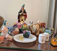 Overall view of the collection showing various figurines, floral ceramics, and small decorative items.