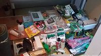Photo of assorted garden supplies including bottles, tools, small items spread on a flat board