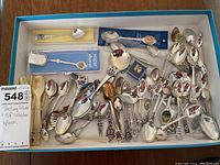 Box with all souvenir spoons laid out
