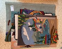 Stack of 4 fabric wall hangings showing coastal and abstract designs on textured textile fabric.