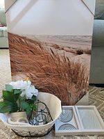 Full lot arranged showing the large beach print, two smaller prints, basket with faux flowers, candle holder, and twig wreath.