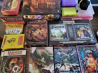Overview of game boxes and storage organizers on floor